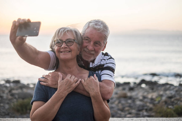 пара літніх людей, які приймають селфі на пляжі щаслива подружня пара, що насолоджується жінка в окулярах
  - Фото, зображення