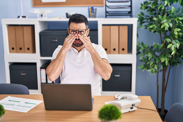 Young hispanic man business worker stressed working at office - Photo, Image