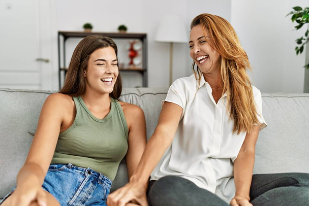 Mother and daughter smiling confident sitting on sofa at home - Φωτογραφία, εικόνα