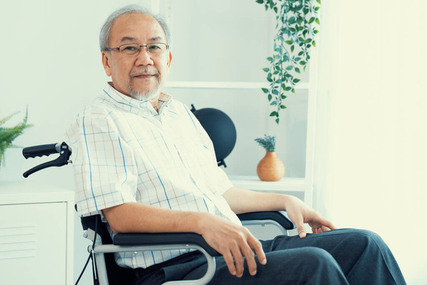Portrait of a contented elderly man in sitting on a wheelchair at home. Senior person in nursing house service . - Φωτογραφία, εικόνα