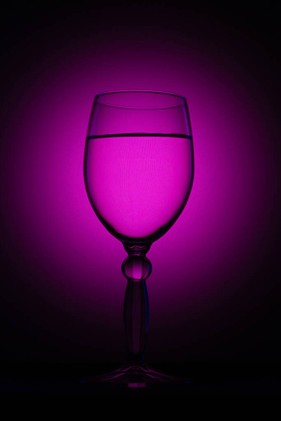 a glass on a black background with light - Photo, image