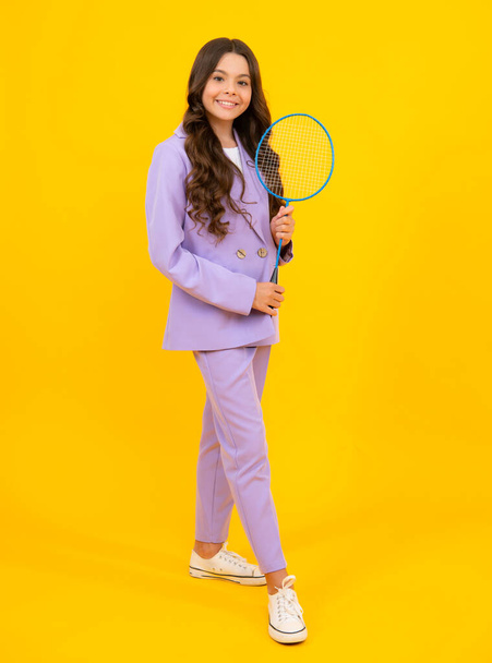 Teen girl badminton player with badminton racket isolated on yellow background - Photo, Image