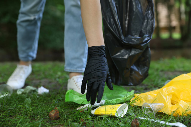 Woman with plastic bag collecting garbage in park, closeup - Photo, Image