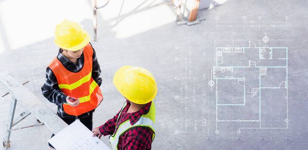 Architect and client discussing help create plan with blueprint of the building at construction site floor. Asian engineer foreman worker man and woman meeting and planning construction work, top view - Foto, Bild