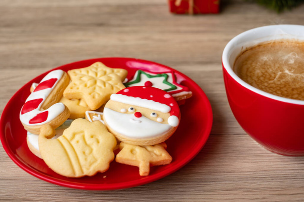 Merry Christmas with homemade cookies and coffee cup on wood table background. Xmas eve, party, holiday and happy New Year concept - Foto, imagen