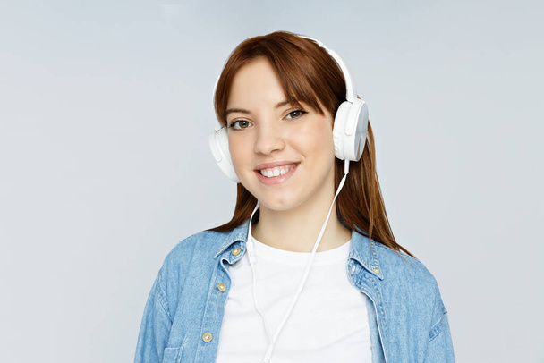 Concept of people, girl with headphones on light background - Foto, immagini