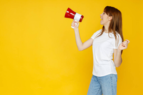 Concept of people, girl with megaphone on yellow background - Photo, image