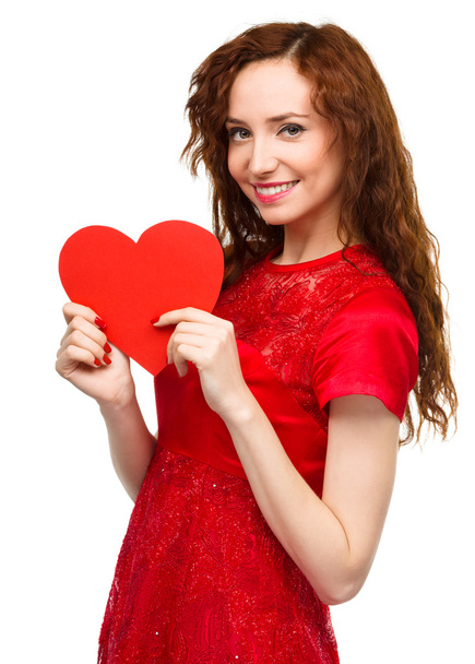 Young woman holding red heart - Valokuva, kuva