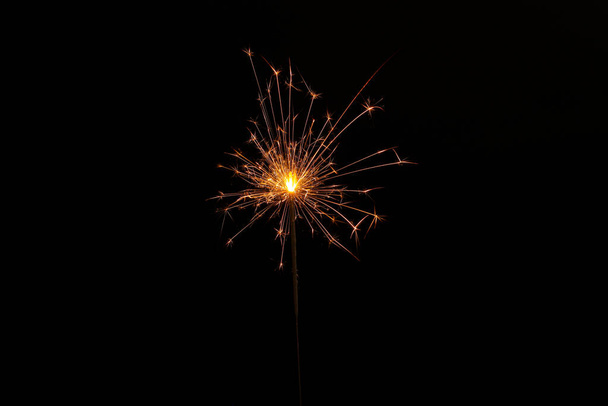 One burning sparkler stick on black background - Foto, immagini