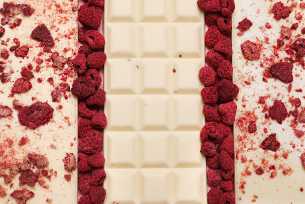 White chocolate bars with freeze dried fruits as background, closeup - Φωτογραφία, εικόνα
