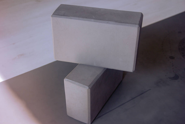 Two gray yoga blocks, foam yoga blocks on a mat, selective focus - Photo, Image