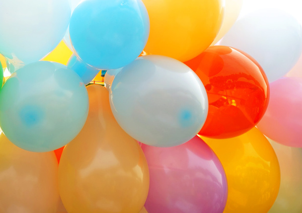 Many colored balloons forming a bright background - 写真・画像