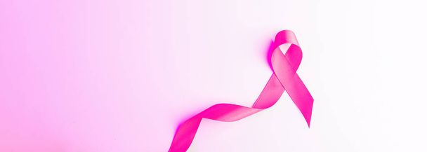 Cancer day. Health care symbol pink ribbon on white background. Breast cancer woman support concept with copy space - Photo, image