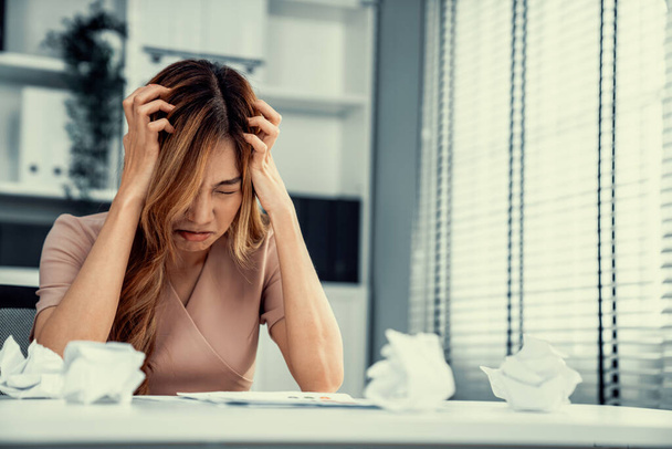 A competent female employee who has become completely exhausted as a result of overburdened work. Concept of unhealthy life as an office worker, office syndrome. - Foto, Bild