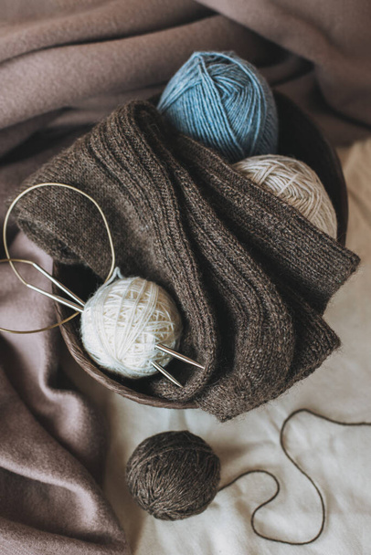Hand knitted socks with needles and yarn ball. Concept for handmade and hygge slow life. - Fotografie, Obrázek