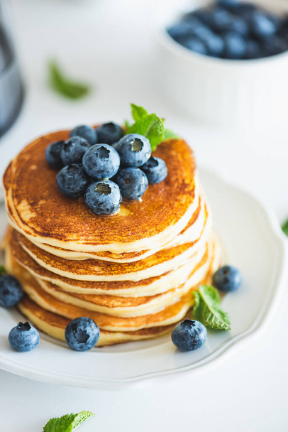 Homemade baked ricotta pancakes with fresh berries on white wooden table - 写真・画像