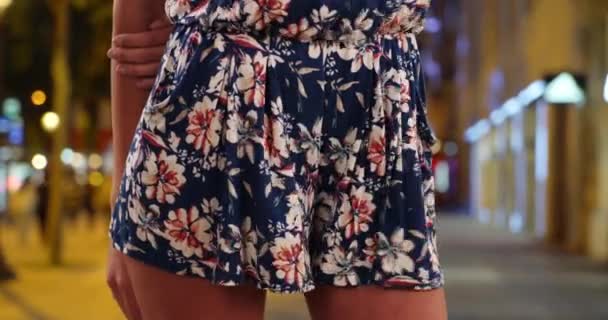 Close-up of mid section of woman in romper with wind blowing on sidewalk in Paris, France. Young stylish lady in casual summer wear standing on Champs-Elysees in Paris. 4k - Footage, Video