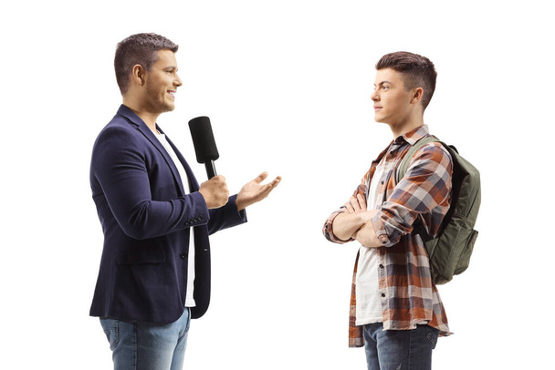 Male journalist with a microphone talking to a male student isolated on white background - Foto, Imagen