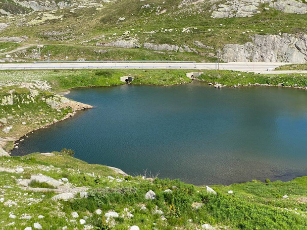 Summer atmosphere on the Lago dei Banchi or Lake Banchi in the Swiss alpine area of mountain St. Gotthard Pass (Gotthardpass), Airolo - Canton of Ticino (Tessin), Switzerland (Schweiz) - Photo, Image