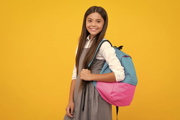 School teen with backpack. Teenager student, isolated background. Learning and knowledge. Go study. Education concept. Happy girl face, positive and smiling emotions - Foto, immagini
