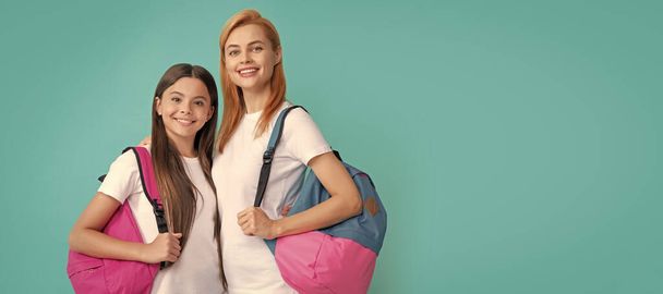 Mother and daughter child banner, copy space, isolated background. happy mother and daughter with backpack ready to study, school time - 写真・画像