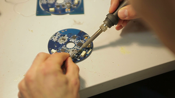 Technician repairing electronic  board with soldering iron. - Footage, Video