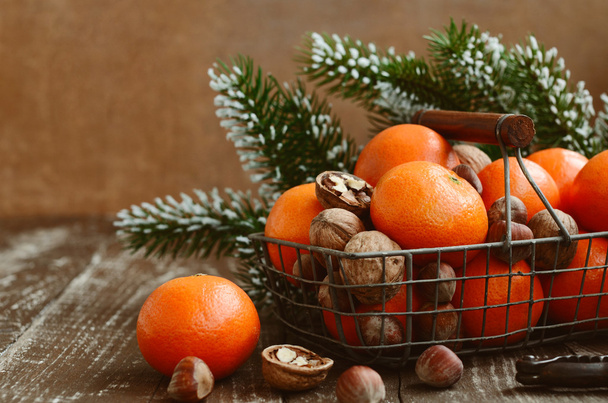 Christmas decoration with tangerines with copy space on wooden b - Photo, image