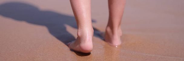 Wet bare feet walk along beach along sea. Keep calm on vacation and being alone concept - Photo, Image