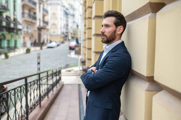 Young man. Young good-looking elegant man on the urban background - 写真・画像