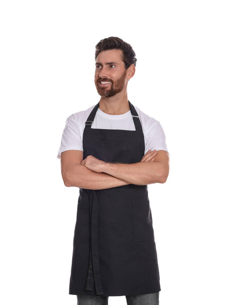 Professional hairdresser wearing apron with crossed arms on white background - Фото, изображение
