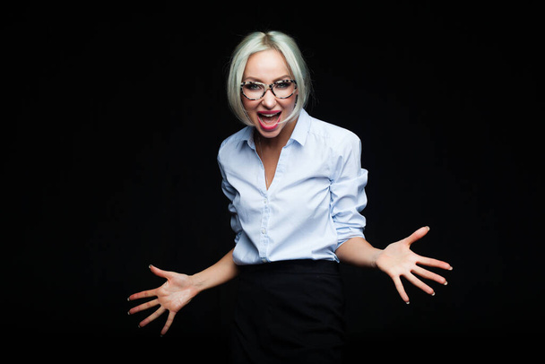 Young emotional woman screaming on black studio background - Photo, Image