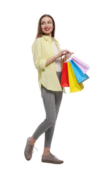 Stylish young woman with shopping bags on white background - Фото, зображення