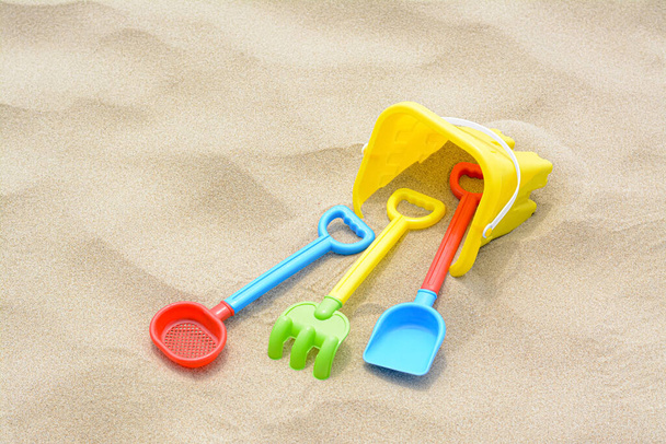 Set of colorful beach toys on sand - Foto, imagen