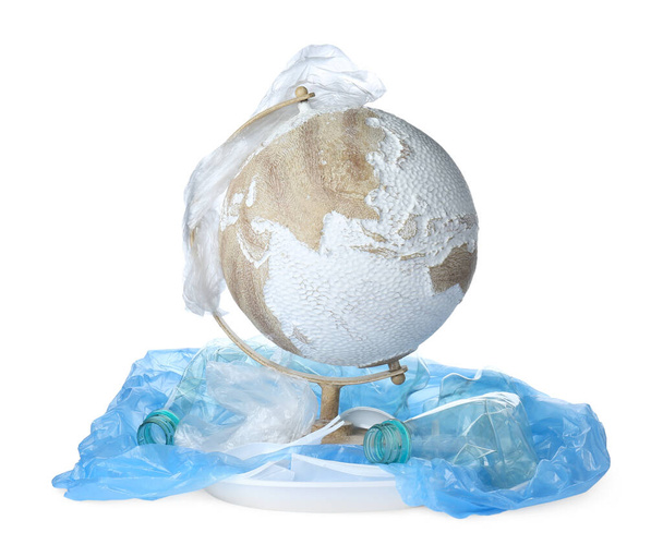 Globe and plastic garbage isolated on white. Environmental protection concept - Fotó, kép