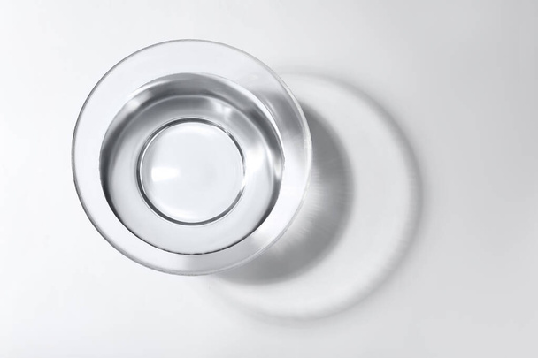 Glass bowl with water on white background, top view - Φωτογραφία, εικόνα