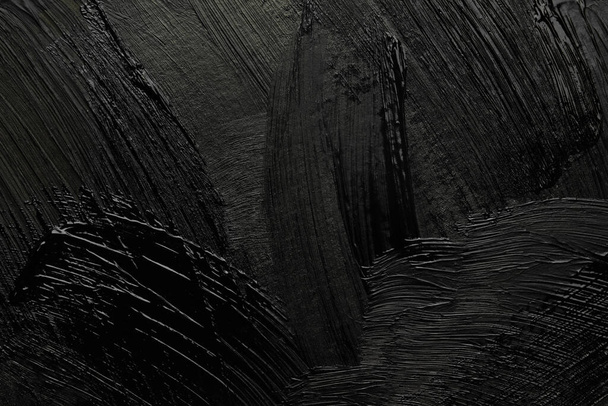 Beautiful strokes of black paint as background, closeup - Фото, изображение