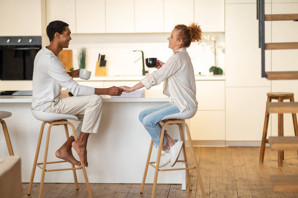 Morning together. Couple spending time together and having breakfast in the kitchen - Fotografie, Obrázek