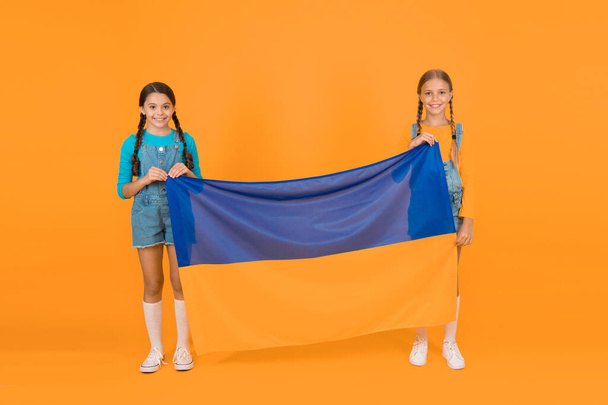 Patriotism respect and love to motherland. National identity concept. Ukrainian kids. Girls with blue and yellow flag. Patriotic education. Happy independence day. Children hold ukrainian flag. - Fotó, kép