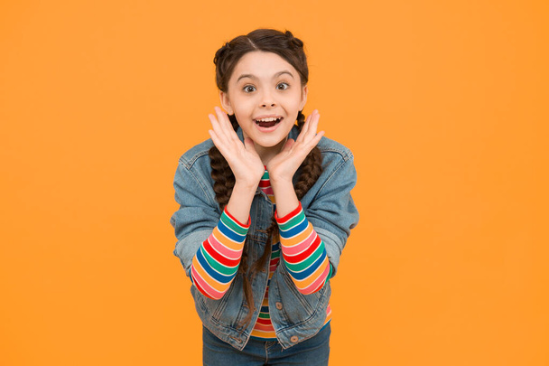 Excited surprised little girl with braids wear denim clothes, childhood dreams concept. - Φωτογραφία, εικόνα