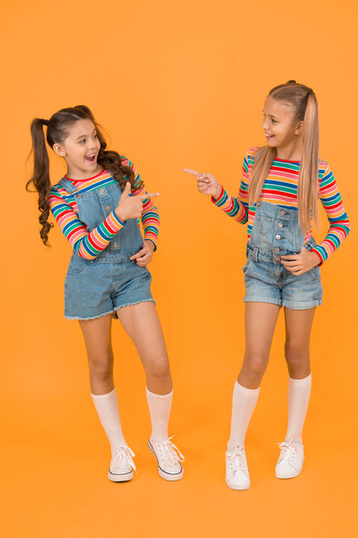 Must have accessory. Vibrant colors. Modern fashion. Kids fashion. Girls long hair. Cute children same outfits. Trendy and fancy. Little girls wearing rainbow clothes. Matching outfits. Fashion shop. - Foto, imagen