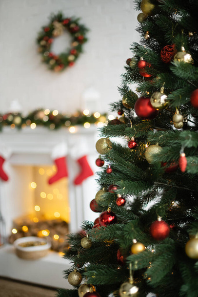 Decorated christmas tree in blurred living room  - Valokuva, kuva