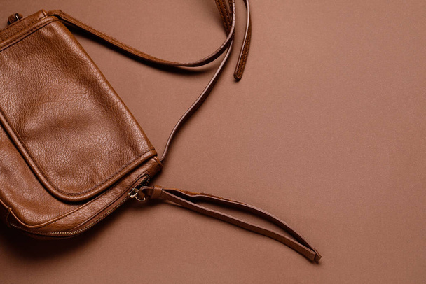 Stylish leather handbag on brown background - Photo, image