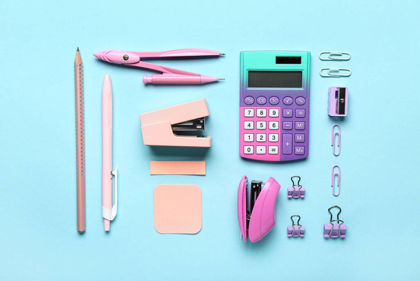 Set of different stationery with staplers on color background - Photo, Image