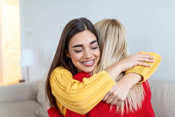 Candid diverse girls best friends embracing standing indoors, close up satisfied women face enjoy tender moment missed glad to see each other after long separation, friendship warm relations concept - Fotoğraf, Görsel