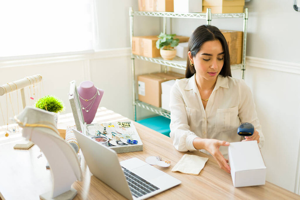Femme vendeur en ligne numérisant les paquets à envoyer aux clients de sa boutique en ligne - Photo, image