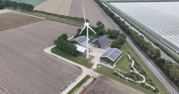 Современная сельскохозяйственная ферма с солнечными батареями и ветряной турбиной для генерирующей компании. Дом и бизнес в производстве продуктов питания. - Кадры, видео