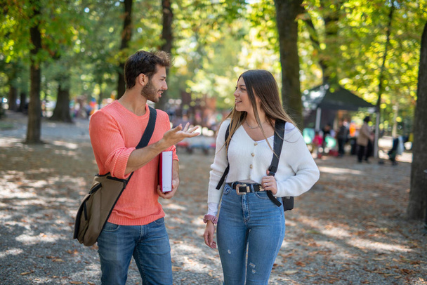 College students walking and talking in a park near their university - Φωτογραφία, εικόνα
