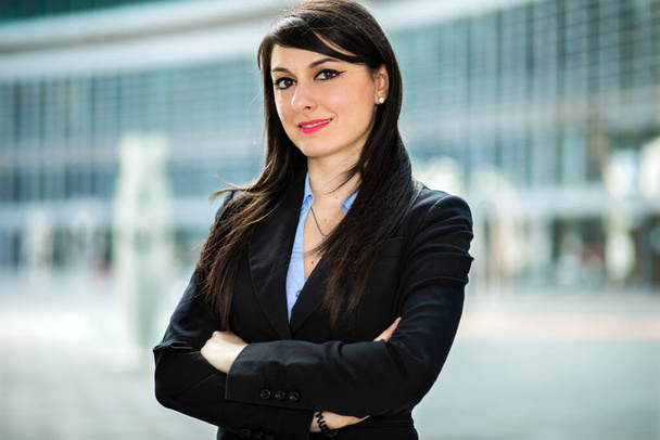 Smiling businesswoman portrait outdoor in a modern setting - Фото, изображение