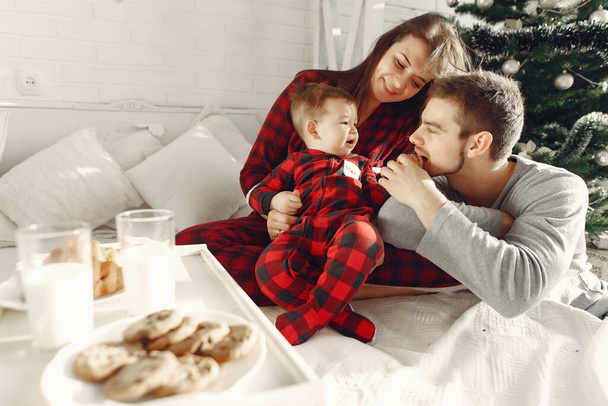 People at home. Family in a pajamas. Milk and croissants on a tray. - Photo, Image