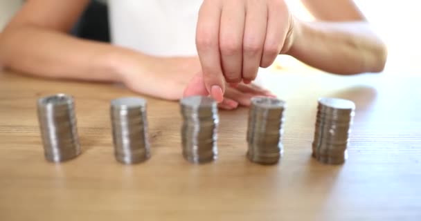 Businesswoman stacks of coins and moves forward. Economic financial growth inflation and money income and crisis - Footage, Video